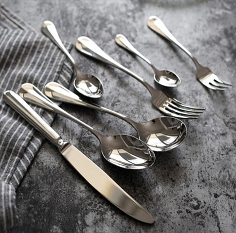 silver-colored cutlery with sable (dark/earthy) tone finish